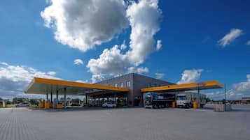 A gas station with a clear sky and clouds.