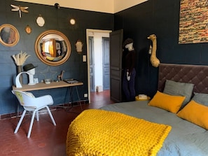 A bedroom with a bed, a desk, and a chair. There is a mirror on the wall and a door leading to another room. - Casa Moz House, Pool, Petanque (Marseille)