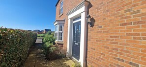 A residential property with a brick exterior, a front door, and a visible number '28' on the door. - Sprawling 7-Bed Retreat in the Heart of Warboys (Warboys)