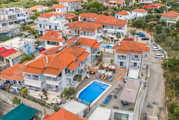 A residential area with multiple two-story houses, each with a red-tiled roof and balconies.