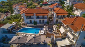 A residential area with a swimming pool, multiple balconies, and a clear view of the surrounding neighborhood.