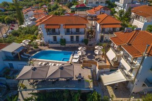 A residential area with a swimming pool, multiple balconies, and a clear view of the surrounding neighborhood.