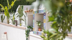A small, enclosed outdoor area with a tiled wall, potted plants, and a cactus. - Villa ALMASUR by Abahana Villas (Benissa)