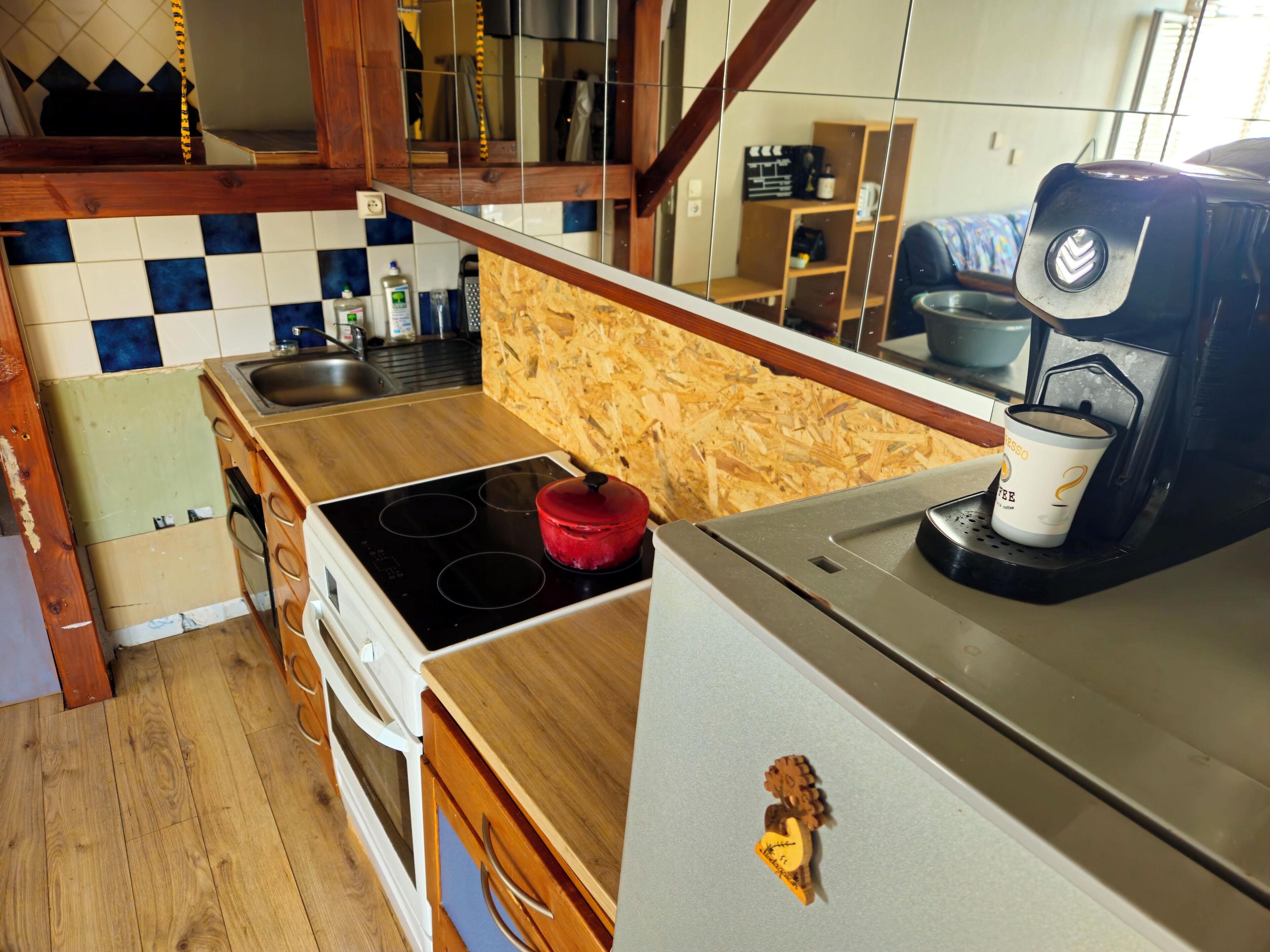 Une cuisine équipée d’un plan de travail en bois, d’une cuisinière, d’une machine à café et d’un réfrigérateur.