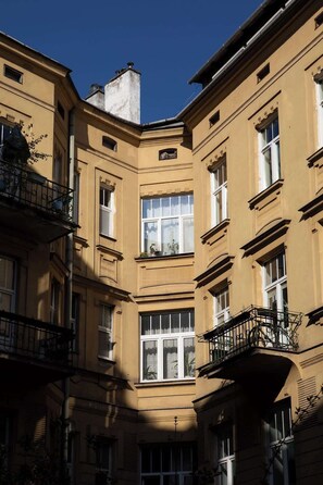 A multi-story building with balconies, large windows, and a clear sky. - Charm & Chic Studio 14.2 | Main Old Town & Planty (Kraków)
