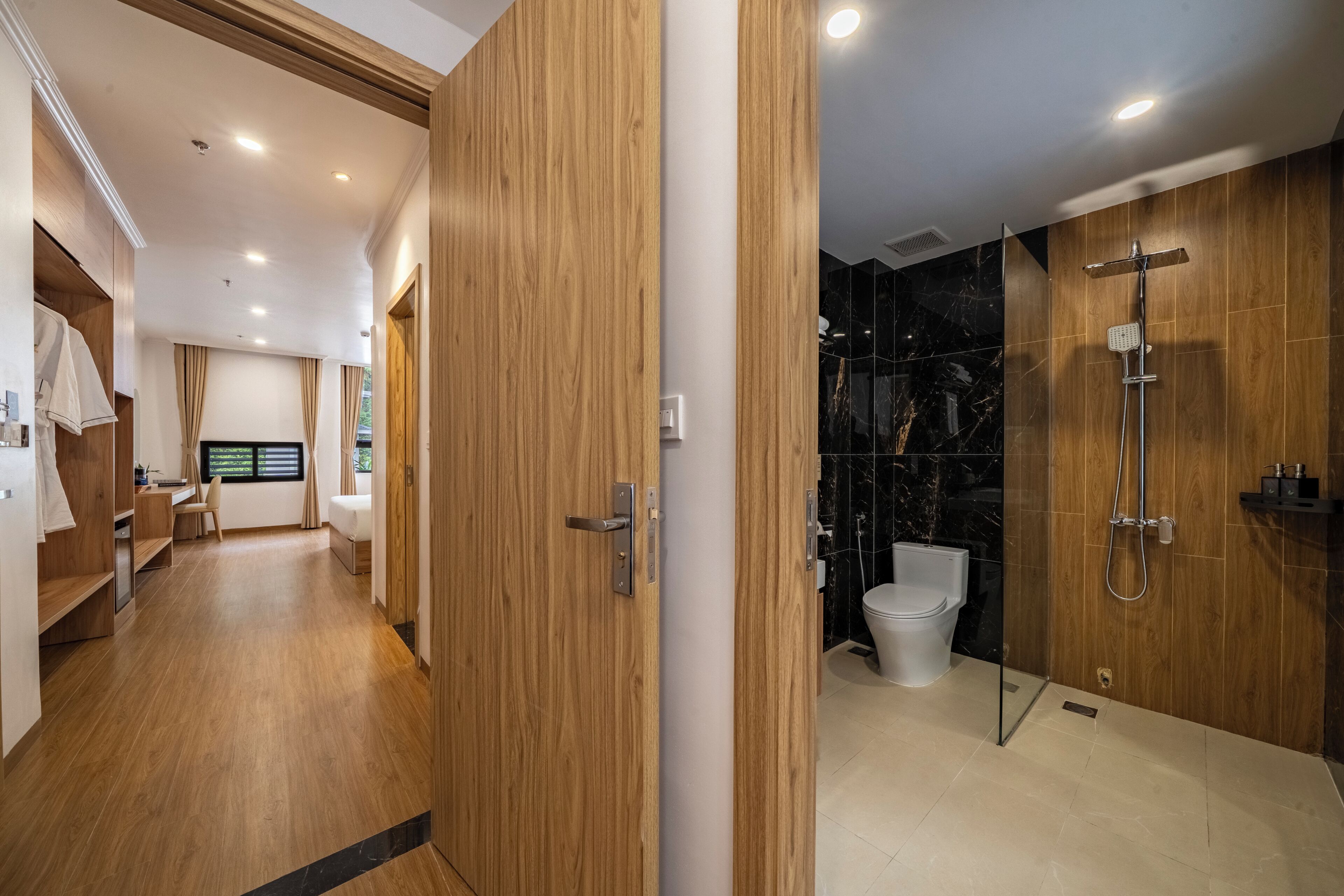 A modern bathroom with a shower, toilet, and vanity.