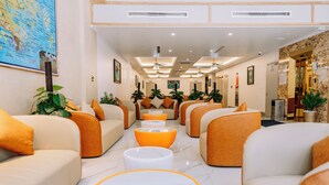 A hotel lobby with seating areas, a reception desk, and a map on the wall. - Catba Vista Hotel (Hai Phong)