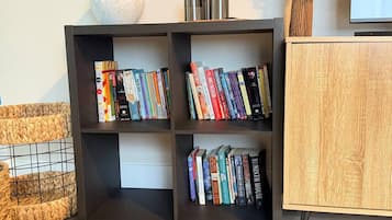 A bookshelf with multiple shelves, some books, and decorative items.