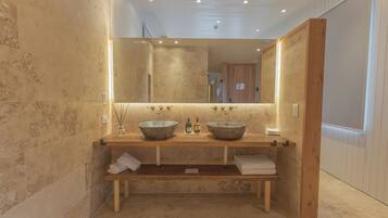 Deluxe Suite | Bathroom | Hair dryer, slippers, towels, soap