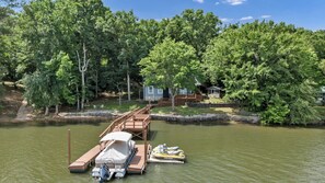 A lakeside property with a dock, a covered boat, and a jet ski. - Sunset Cove @ Wateree- 2-bedrooms, 2-bathrooms, near Wateree Creek Landing (Winnsboro)