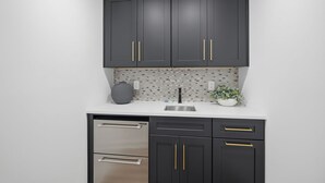 A kitchen with dark cabinets, a stainless steel dishwasher, and a tiled backsplash. - Beautiful 5-bedroom lodge in Jasper Georgia (Big Canoe)
