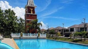 A swimming pool with a white fence and a water slide. - Paradise Away From Home | Elegant Lakeview Villa with Pool in Central Pattaya (Chon Buri)