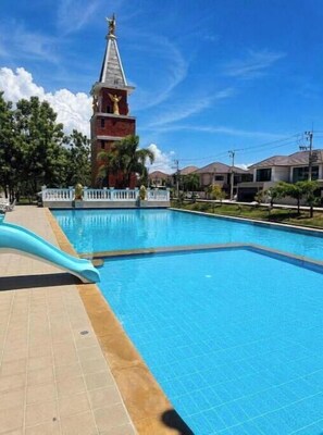 A swimming pool with a white fence and a water slide. - Paradise Away From Home | Elegant Lakeview Villa with Pool in Central Pattaya (Chon Buri)