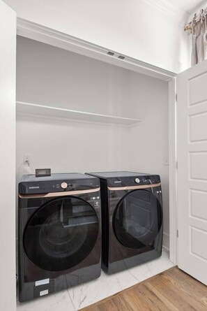 A laundry room with two Samsung washing machines. - Soak it up in East! 8 beds 3.5 bath Garage incl! (Nashville)