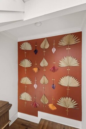 A wall with a collection of paper fans arranged in a grid pattern. - Soak it up in East! 8 beds 3.5 bath Garage incl! (Nashville)