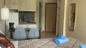 A hotel room with a bed, a desk, and a kitchenette. - SEAL of Knight - Castle View - Downtown near the Beach (Rodos)