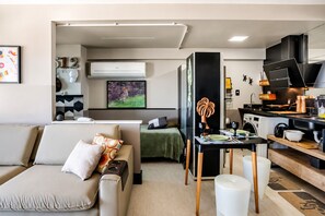 A compact living space with a kitchenette, a sofa, a dining table, and a bed. - Incredible Ocean View•Swimming pools•Academy•Wi-Fi•Vacancy (Salvador)