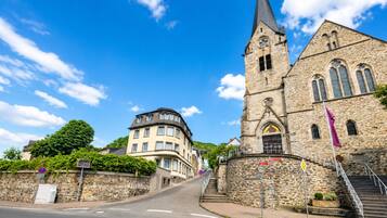 A church with a tall steeple and a stone facade.