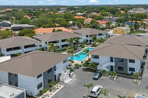 A residential area with multiple two-story buildings, a swimming pool, and a parking area. - Azure stay - Luxury Stay - Pool - Santa Rosa (Mahaai)