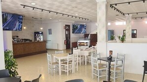 Un espace intérieur vaste et bien aménagé, avec différents types de sièges, notamment des tables et des chaises, ainsi qu'un comptoir d'accueil.