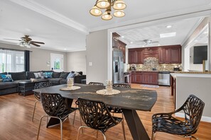 A modern kitchen with dark wooden cabinets, stainless steel appliances, and a stone backsplash. - Best of Grandview! 7 Beds, waterfront & dock! (Hampton)