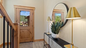 A wooden door leading to a balcony with a view of a forested area. - Perfect Family Getaway: 4BR with Stunning Alpine Views (Keystone)