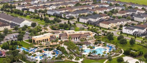 A residential area with a large swimming pool surrounded by houses.