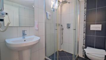 Shower, hair dryer, slippers, towels