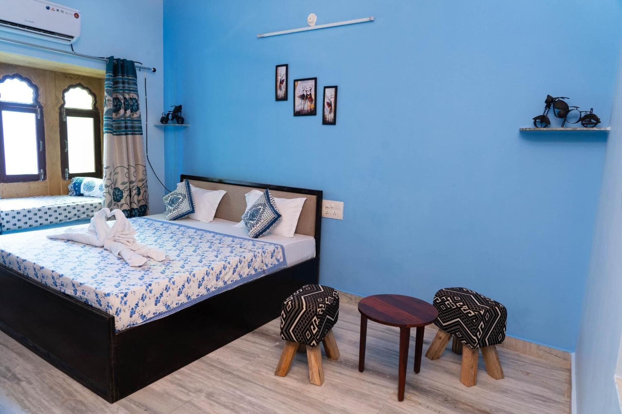 A bedroom with a bed, bedside tables, a chair, and a small table.