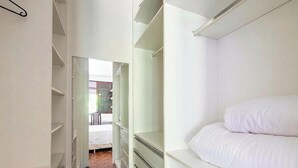 A bedroom with a bed, a wardrobe, and a door leading to a bathroom. - House w/ Pool & Balcony in Salvador Api0062 (Salvador)