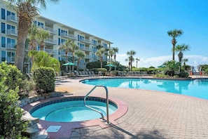 A hotel with a pool area, including a hot tub and lounge chairs. - The Crescent 403 (Miramar Beach)