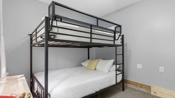 A bunk bed with a white mattress and a single yellow pillow. - Lakefront Home 3 Bedroom 2 Bath With Private Dock (Gravois Mills)
