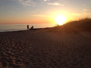 A beach with sand dunes and a sunset in the background. - Hilltop Haven, Stunning Lake Michigan Views (Muskegon)