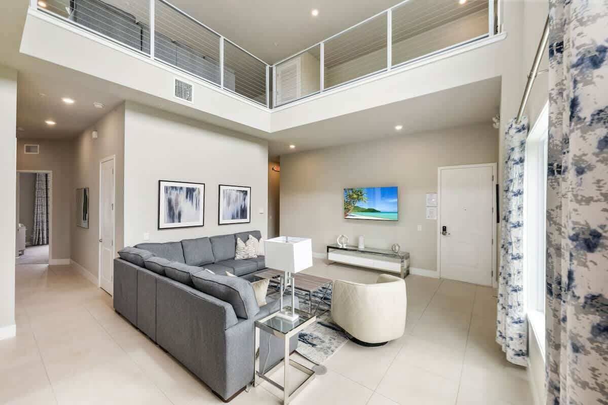 Unit 222 Living Room: The heartbeat of the home, plush seating, soaring height, and seamless connection throughout.
