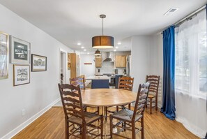 Dining room table leading into the kitchen