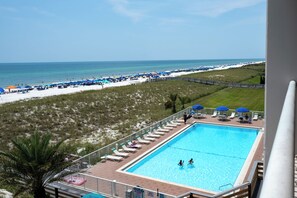 A pool area with a view of the beach and ocean. - Regency 308 -NEW LISTING AS OF AUGUST 2026! Sea You on the Flip Tide! (Navarre)