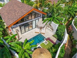 A modern house with a swimming pool, surrounded by lush greenery and palm trees. - Paje Emerald Escapes (Zanzibar)