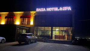 A building with a sign reading 'BAZA HOTEL & SPA' at night. - BazaHotel&Spa (Mil)