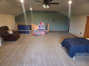 A room with a ceiling fan, a bunk bed, a chair, and a bed. - House just minutes from the Yellowstone river. (Livingston)
