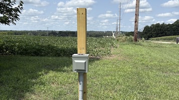 A utility pole with a wooden post and a grey electrical box.