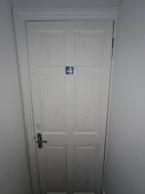 A white door with a number '4' sign on it.