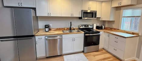 Coffee/tea maker, fridge, microwave, oven