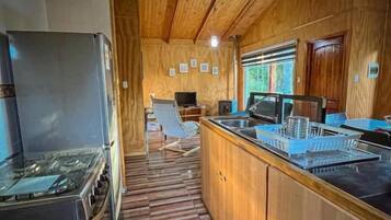 A kitchen with wooden cabinets, a gas stove, and a microwave.