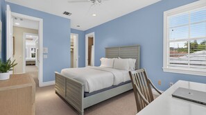 A bedroom with a bed, a desk, a chair, and a window. - Beach Drive Estate by Avantstay Canal-front Pool + Hot Tub + Private Dock Walk to the Beach (Delray Beach)