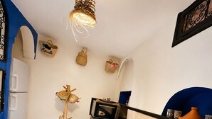 A kitchen with a built-in oven, a sink, and a hanging light fixture. - Charming 5-Bedroom Mini Riad with Patio, Gym and Inspiring Workspace (Marrakech)