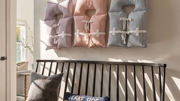A modern interior with a bench and a wall-mounted pillow display.