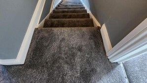 A carpeted staircase with a handrail and a view of a room at the top. - The Ivy (Grays)