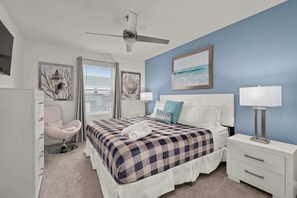 A bedroom with a bed, a chair, a bedside table, a lamp, and a ceiling fan. - Disney Retreat w/ Private Pool & Resort Access (Kissimmee)