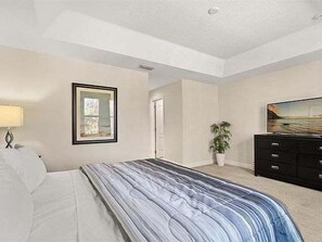 A bedroom with a bed, a dresser, a television, and a framed picture on the wall. - 12 Mi to Disney! Resort Pool, Gym (Davenport)