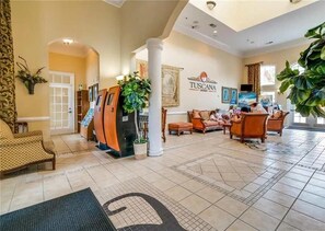 A spacious lobby with a reception desk, comfortable seating, and a large plant. - 12 Mi to Disney! Resort Pool, Gym (Davenport)